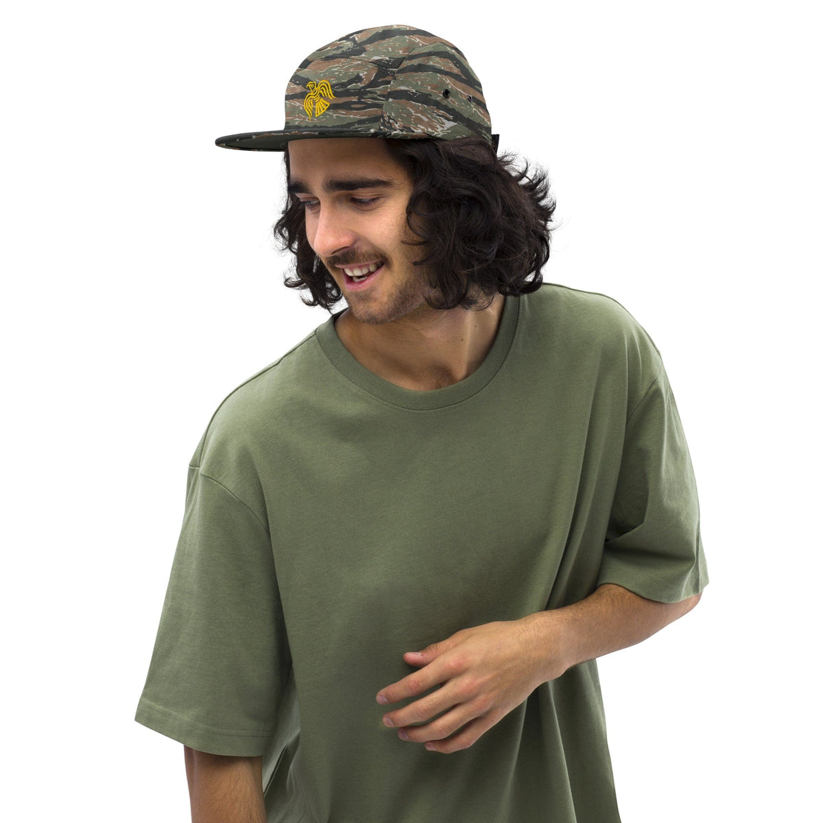 Camo five-panel cap with embroidered yellow emblem and curved brim, worn on head