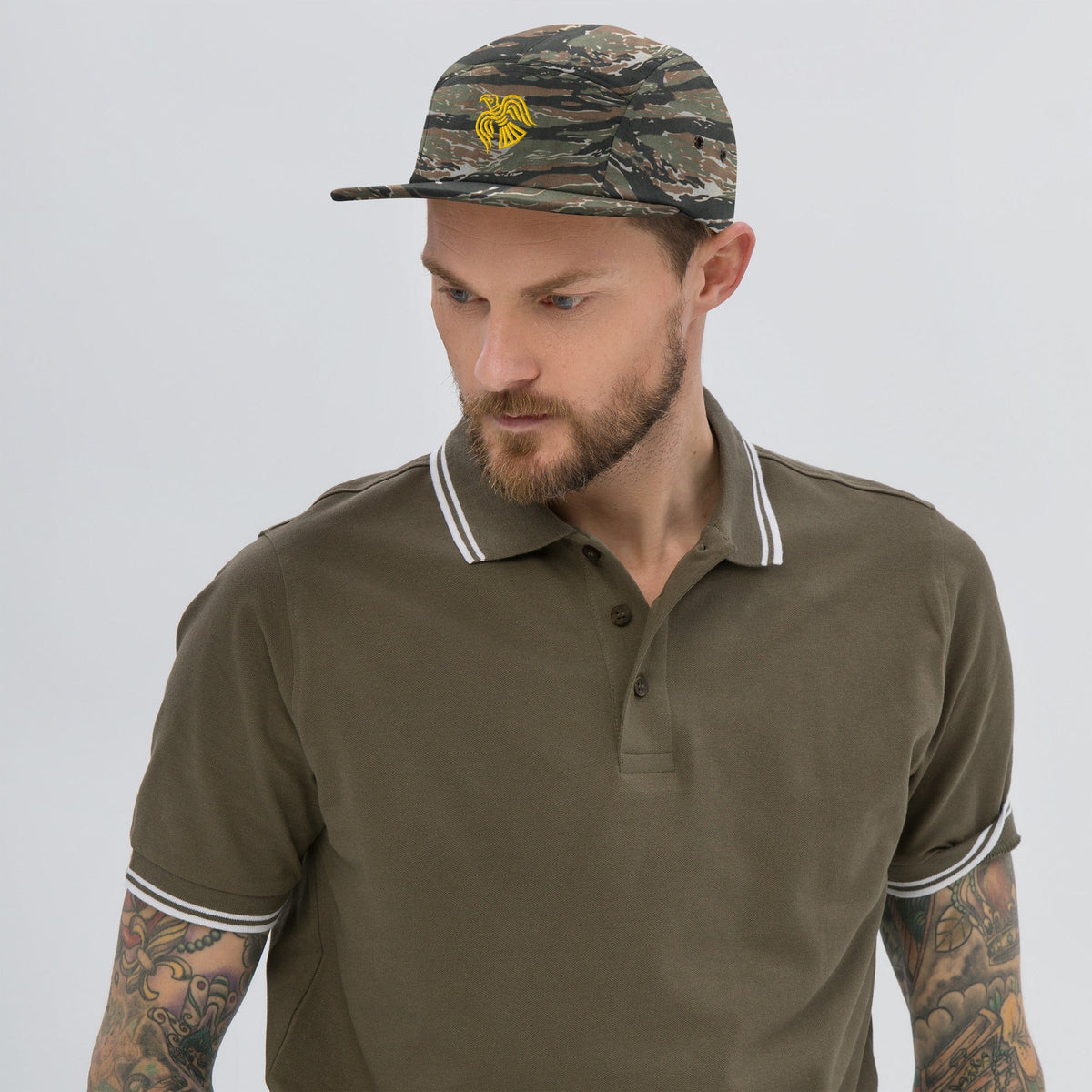 Camo five-panel cap with embroidered yellow Viking raven emblem and curved brim