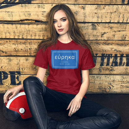 Red crewneck T-shirt with blue “εύρηκα” quote graphic on front.