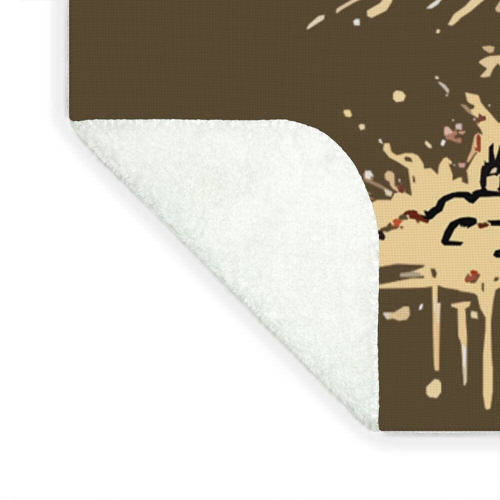 Sherpa fleece blanket corner showing white plush backing and dark printed top edge