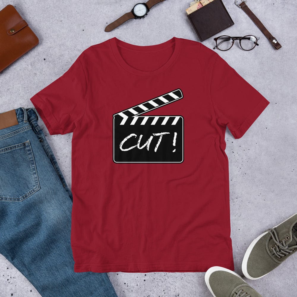 Red T-shirt with film clapper “CUT!” graphic on the chest.