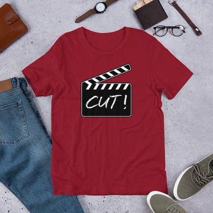 Red T-shirt with film clapper “CUT!” graphic on the chest.