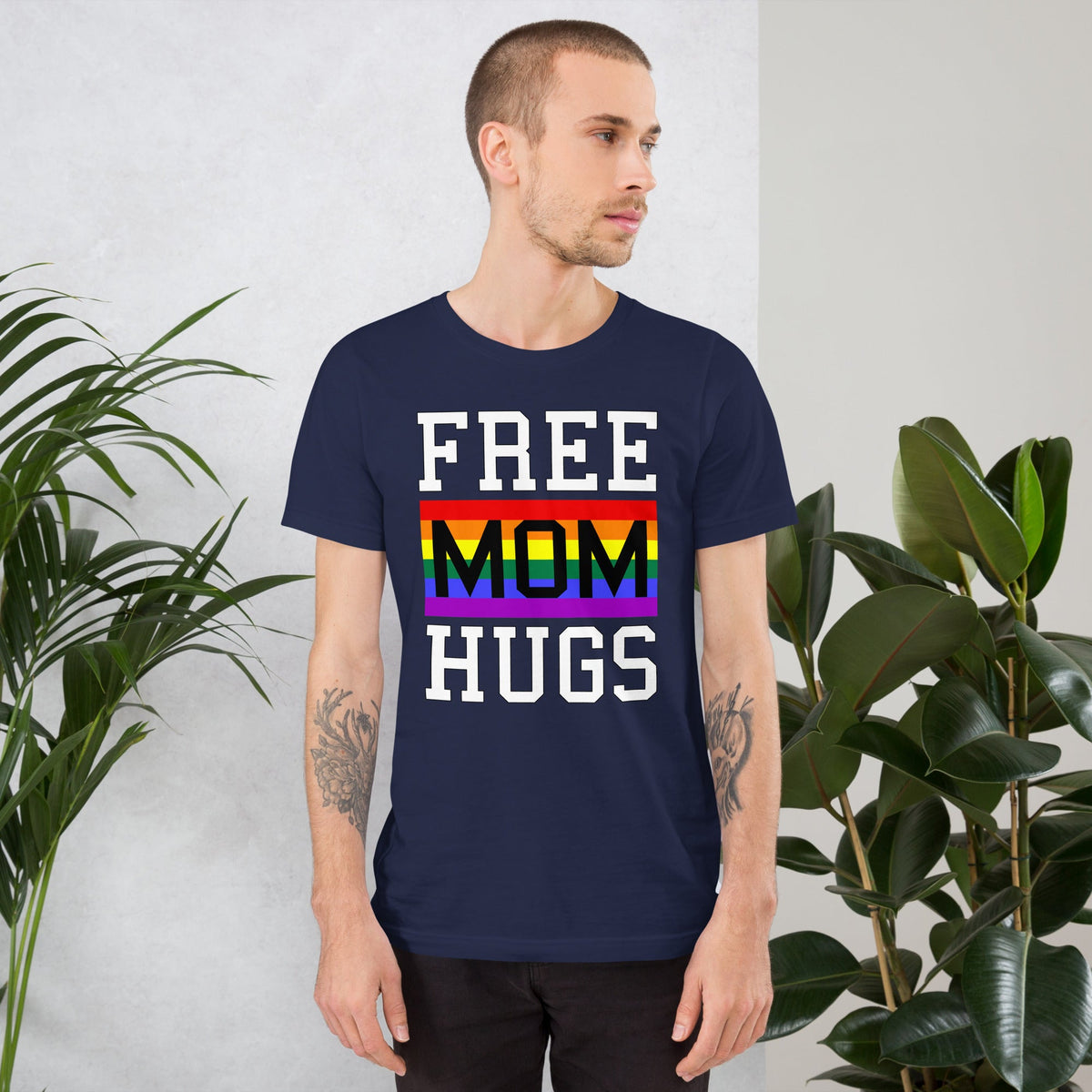 Navy T-shirt with “FREE MOM HUGS” text and a rainbow stripe graphic on the front.