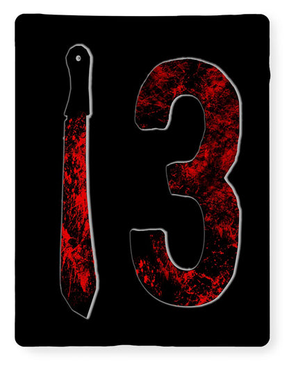 Black fleece blanket with distressed red “3” graphic and dagger-shaped design