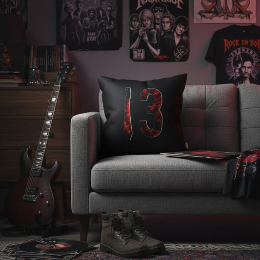 Throw pillow with black cover and red number 3 graphic beside a dagger illustration