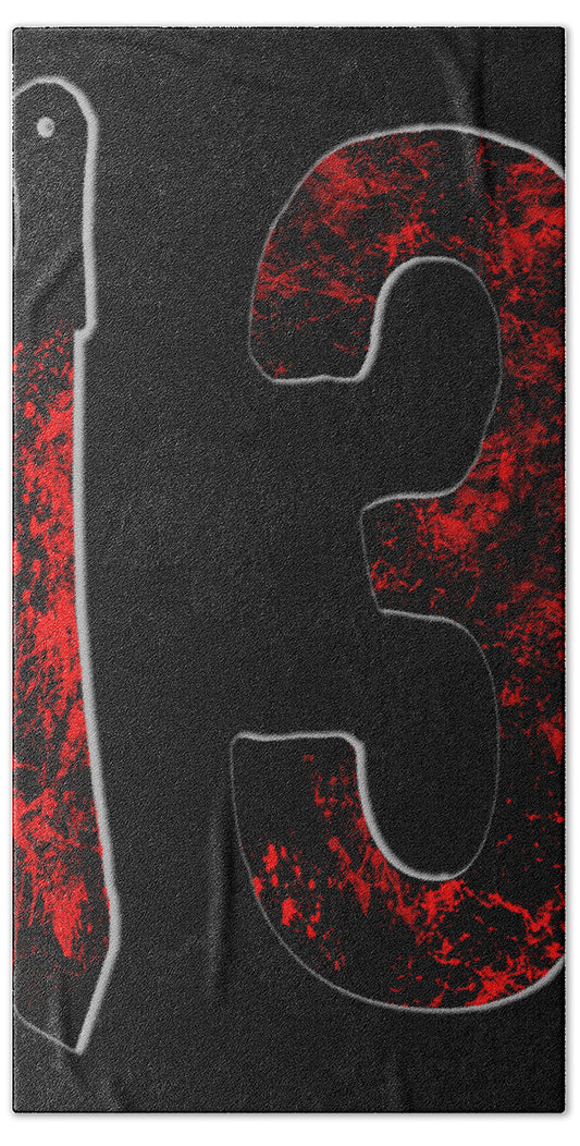 Bath towel with dark gray base and large red splatter graphic with contour shapes