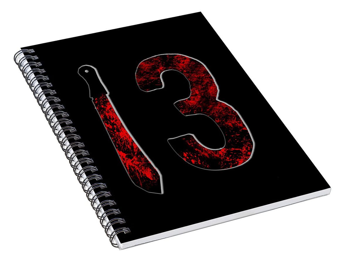 Spiral notebook angled view with black cover and red distressed number 13