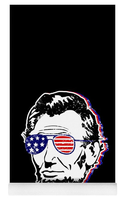 Black yoga mat with Abe Lincoln face graphic and stars-and-stripes sunglasses, bottom trim visible