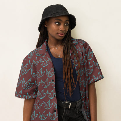 Unisex short-sleeve button shirt with teal leaf print on dark maroon fabric; front.