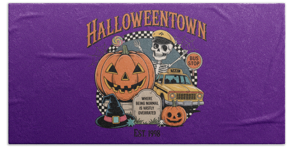 Rectangular purple beach towel with centered HalloweenTown logo, pumpkin and bus stop