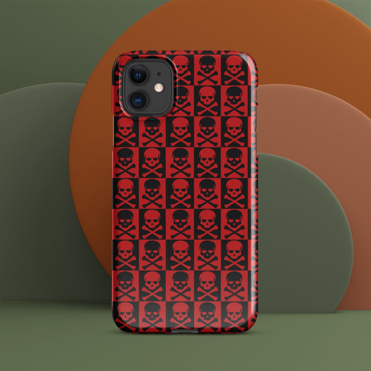 Red snap phone case with repeating black skulls, centered front view