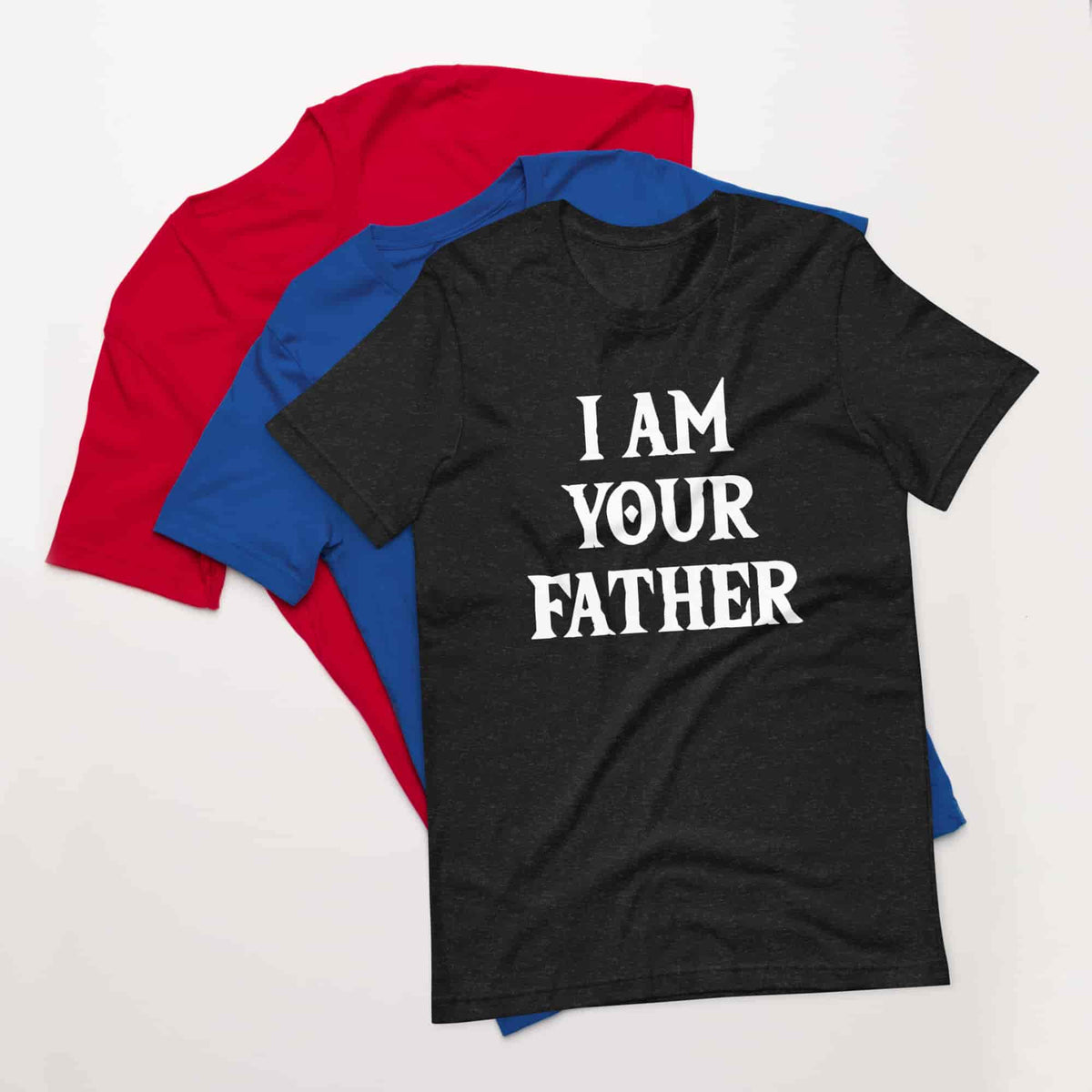 Folded T-shirts in red, blue, and black with white “I AM YOUR FATHER” print
