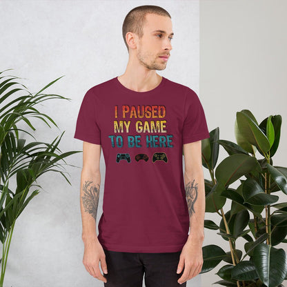 Maroon graphic T-shirt: "I PAUSED MY GAME TO BE HERE" with controller icons