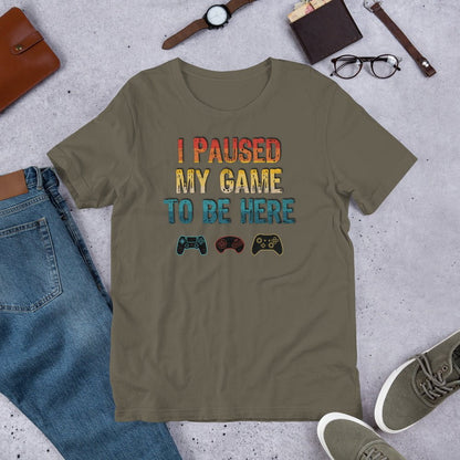 Olive graphic T-shirt: "I PAUSED MY GAME TO BE HERE" with controller icons