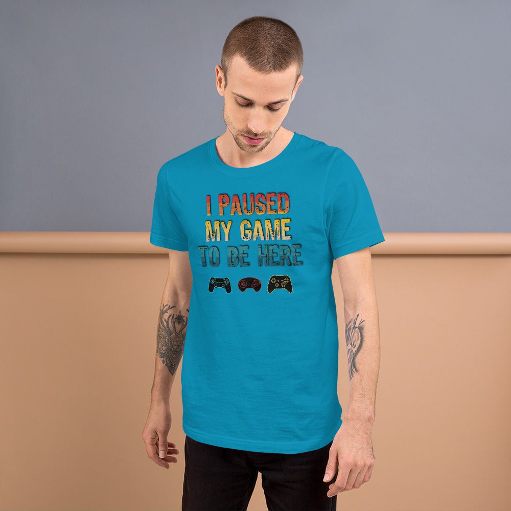 Aqua T-shirt with 'I PAUSED MY GAME TO BE HERE' graphic and game controller icons