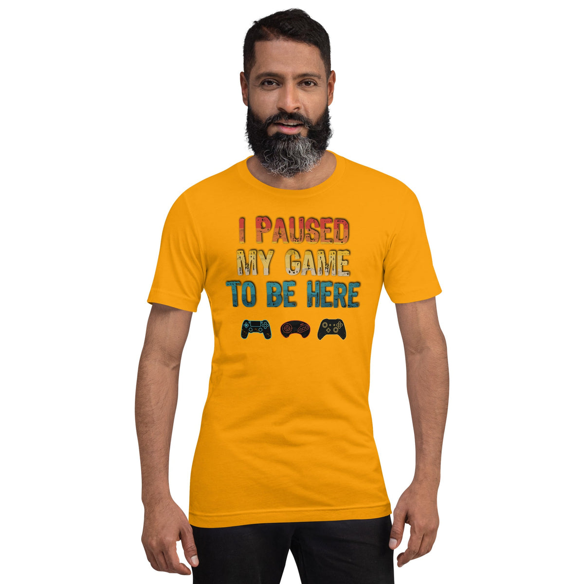 Gold graphic T-shirt: "I PAUSED MY GAME TO BE HERE" with controller icons