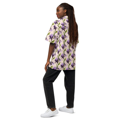 Iris unisex button shirt shown from side: purple flower print with green stems, short sleeves
