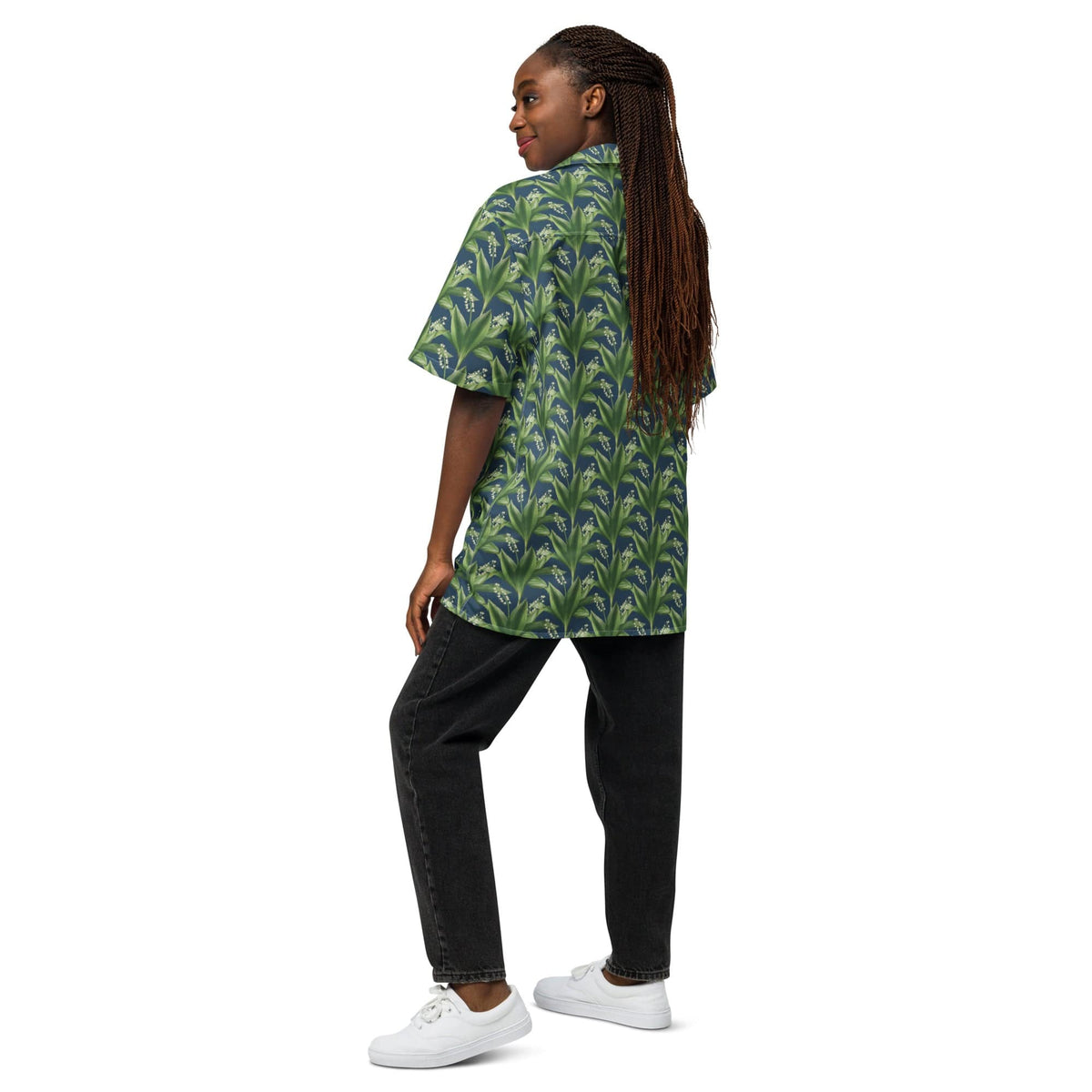 Green leafy print short-sleeve button-up shirt, side view with black pants.