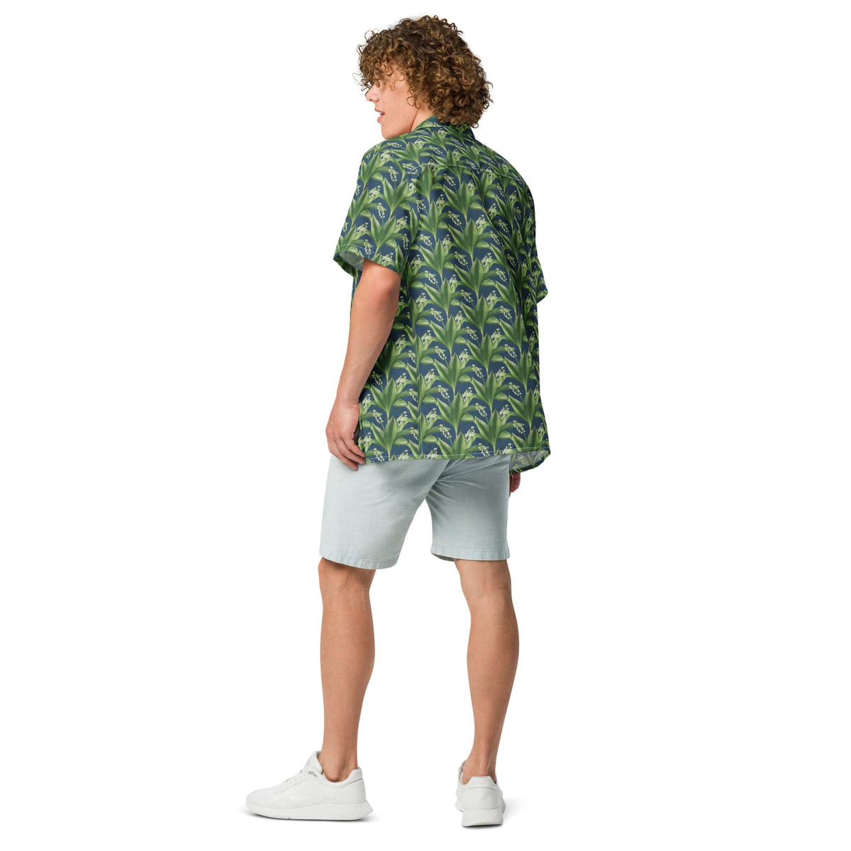 Green leafy print short-sleeve button-up shirt, back view with light shorts.