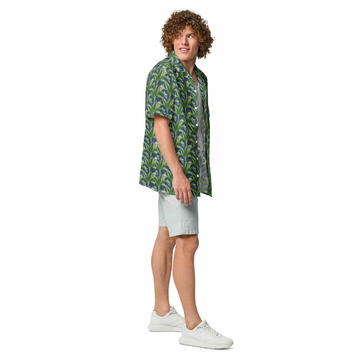 Green leafy print short-sleeve button-up shirt with camp collar, standing pose.