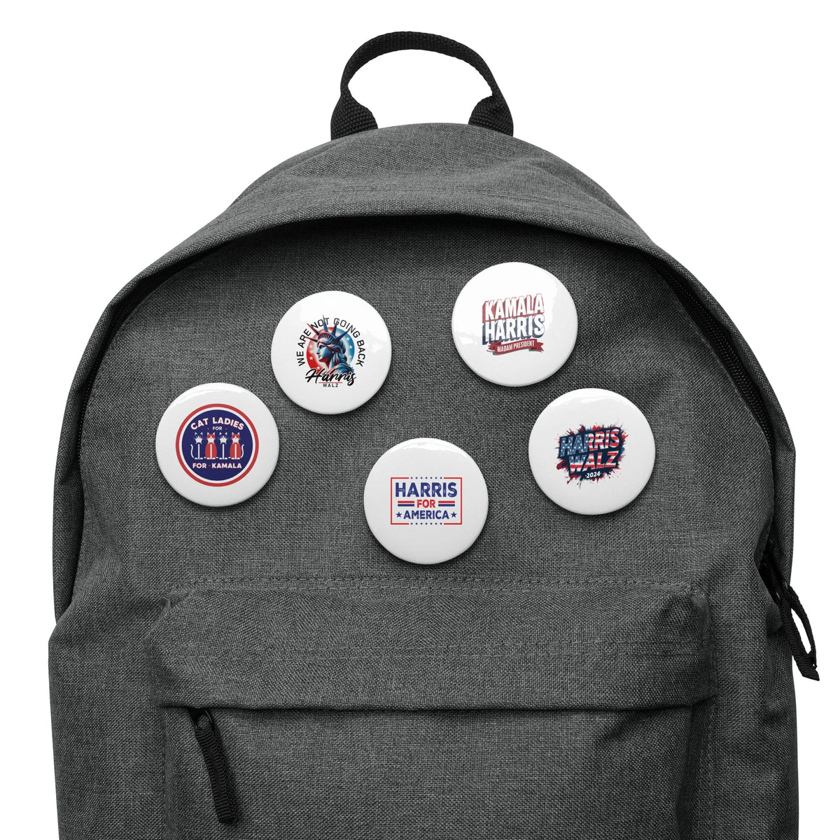 Five round pin buttons attached to the front of a gray backpack