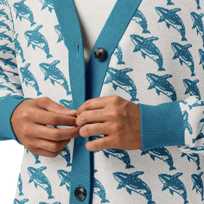 Knitted cardigan button placket with black buttons, blue rib trim, and whale print front