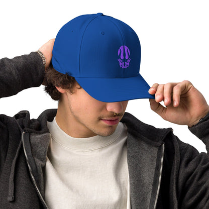 Royal blue embroidered performance cap with purple trident lotus emblem, worn