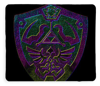 Dark plush blanket with purple and green shield emblem graphic, close view.