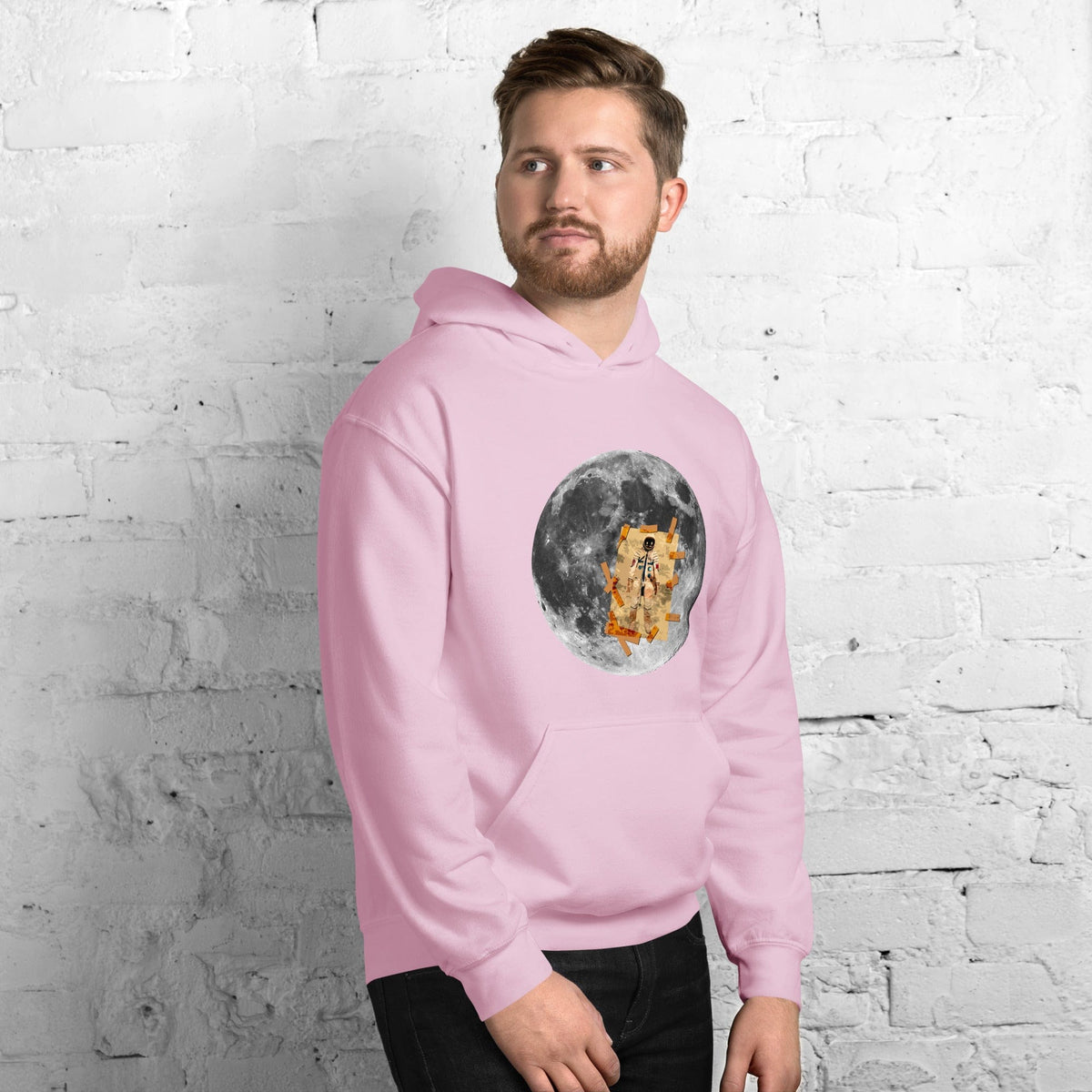 Light pink hoodie with front kangaroo pocket, hood, and circular moon astronaut graphic