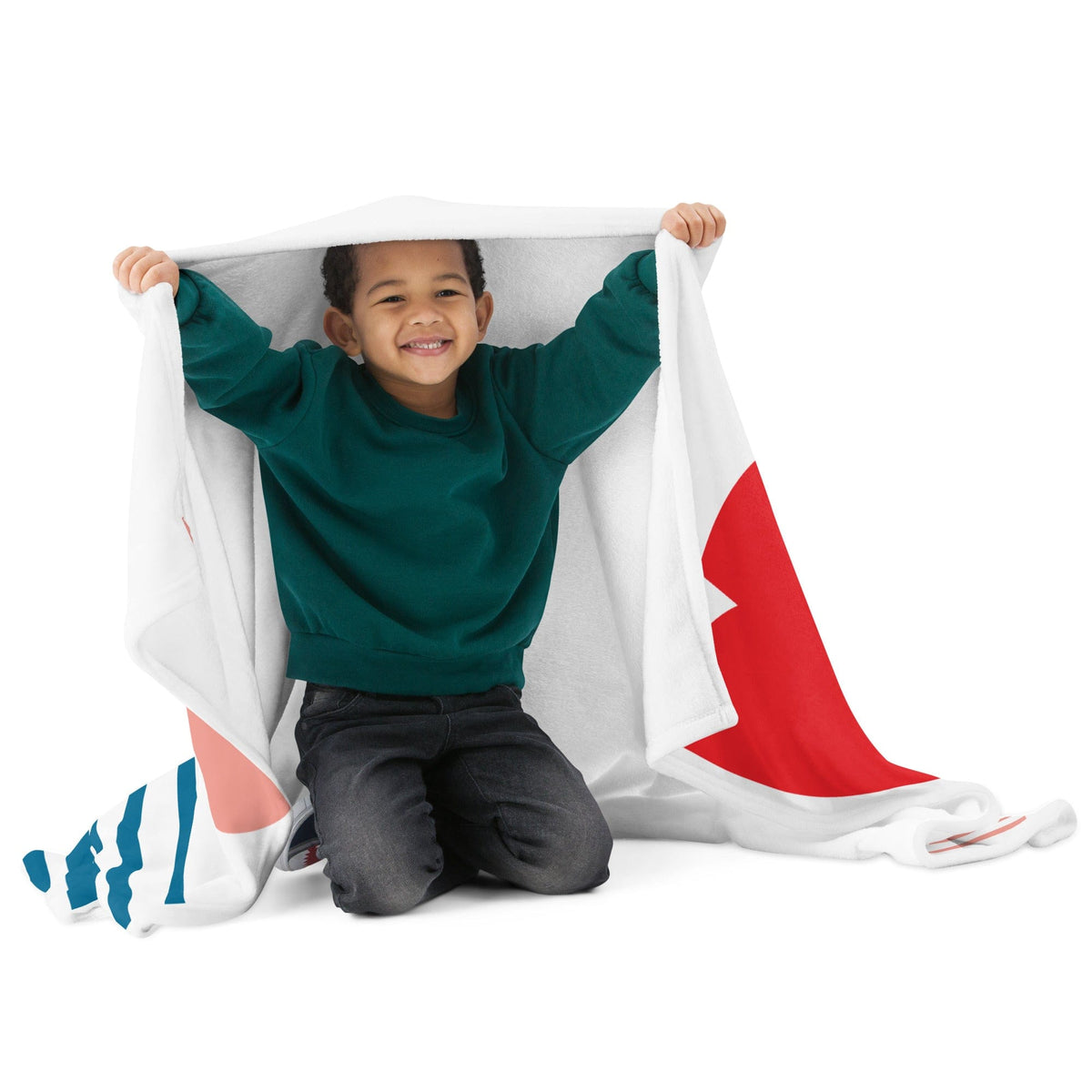 White throw blanket with red sail-like curve, teal/blue stripes, and pink accents, held up.