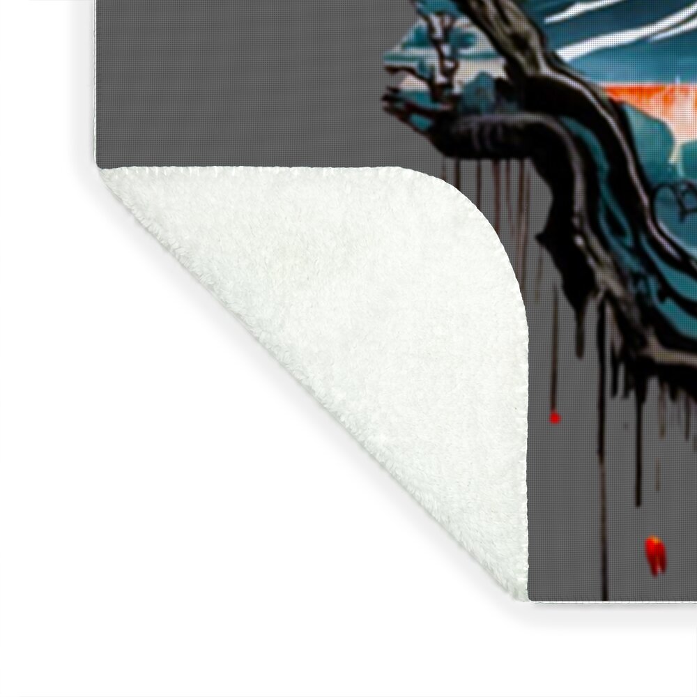 Blanket corner showing white plush backing and printed landscape edge