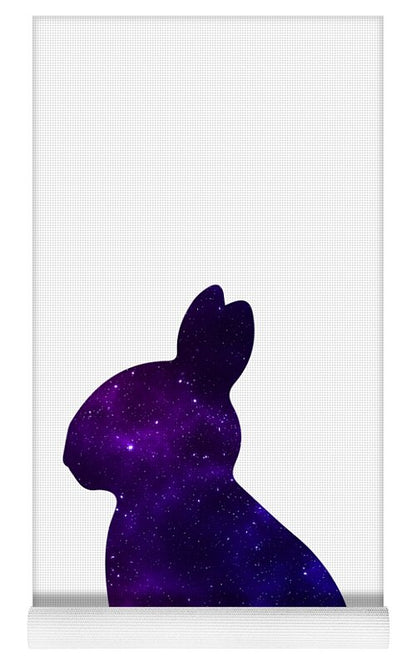 Yoga mat with purple galaxy rabbit silhouette on gridded surface