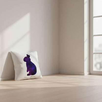 White throw pillow with purple galaxy rabbit graphic, angled view on floor