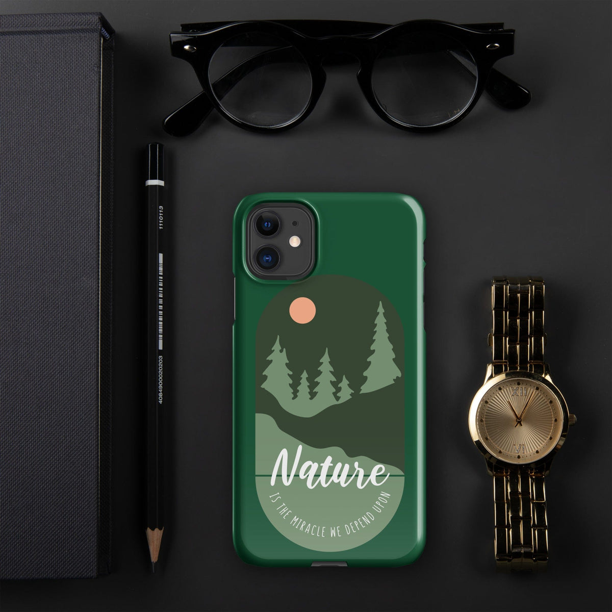Green iPhone snap case with nature landscape graphic, tree silhouettes, and camera cutouts
