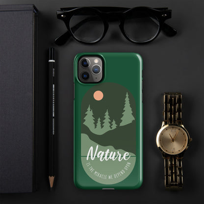 Green iPhone snap case showing nature trees, circular sun icon, and camera cutouts