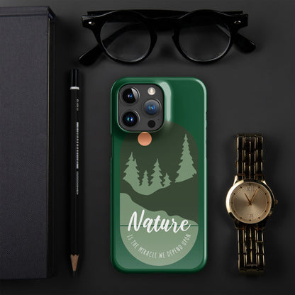 Green iPhone snap case with nature forest artwork, moon dot, and camera cutouts.