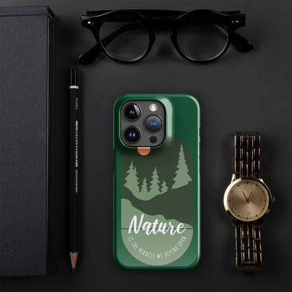Green iPhone snap case with nature trees and moon graphic, visible camera lenses.