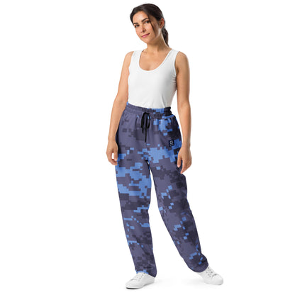 Digital camouflage wide-leg joggers on model, elastic waist and drawstring with tapered cuffs