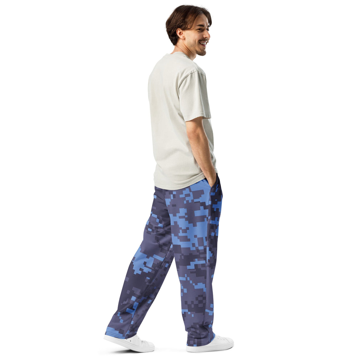 Digital camouflage wide-leg joggers on model, elastic waist with drawstring and roomy legs