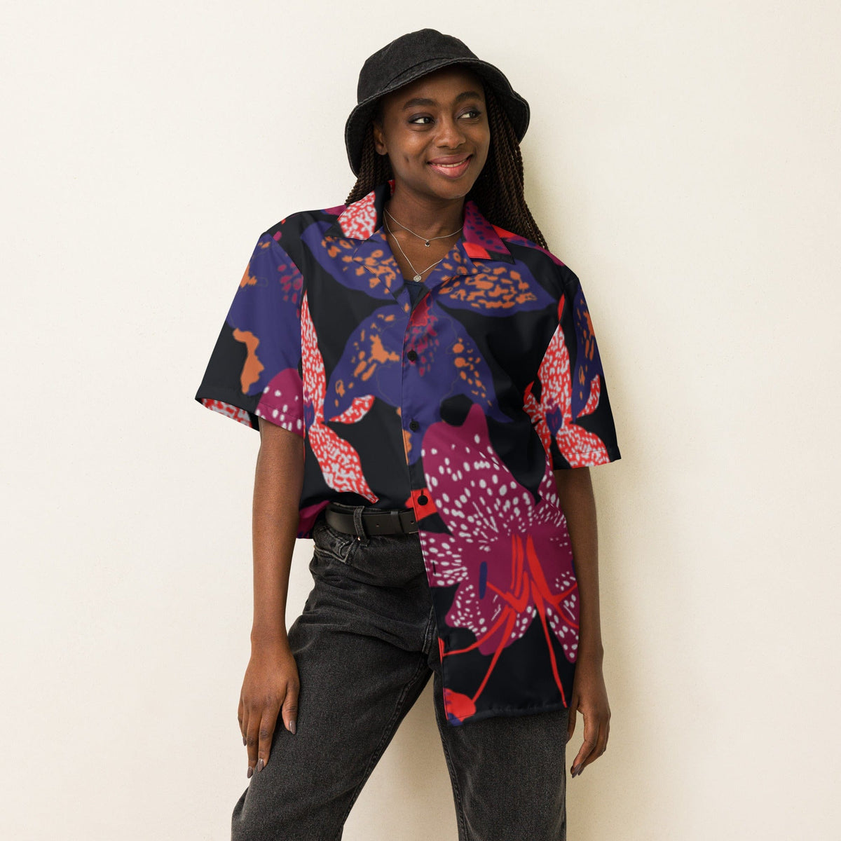 Unisex short-sleeve button-up shirt with dark floral print, worn by model