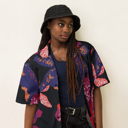 Unisex short-sleeve button-up shirt with dark floral print, close-up on model