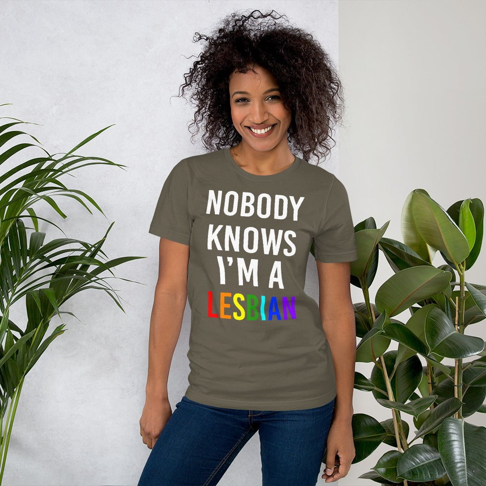 Army green T-shirt with white stacked text and red “LESBIAN” on chest
