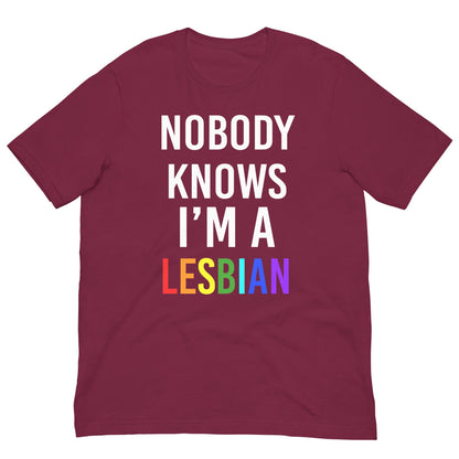 Maroon t-shirt with 'NOBODY KNOWS I'M A LESBIAN' front graphic