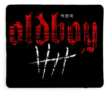 Blanket with large red graphic lettering and white streaked characters on black