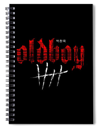 Black spiral notebook with red and white graphic lettering on the cover