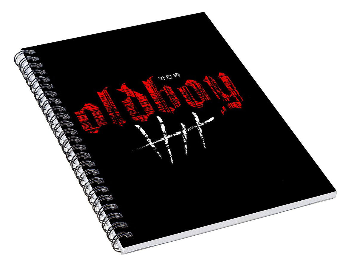 Black spiral notebook with red logo and white scribble graphic on cover
