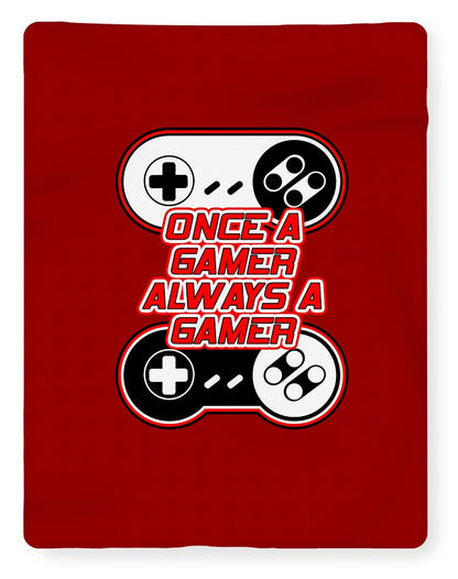 Red gaming blanket with central "Once a Gamer, Always a Gamer" controller graphic