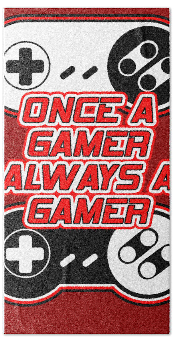 Gamer-inspired bath towel with red text, controller icons, and plus symbols on dark areas