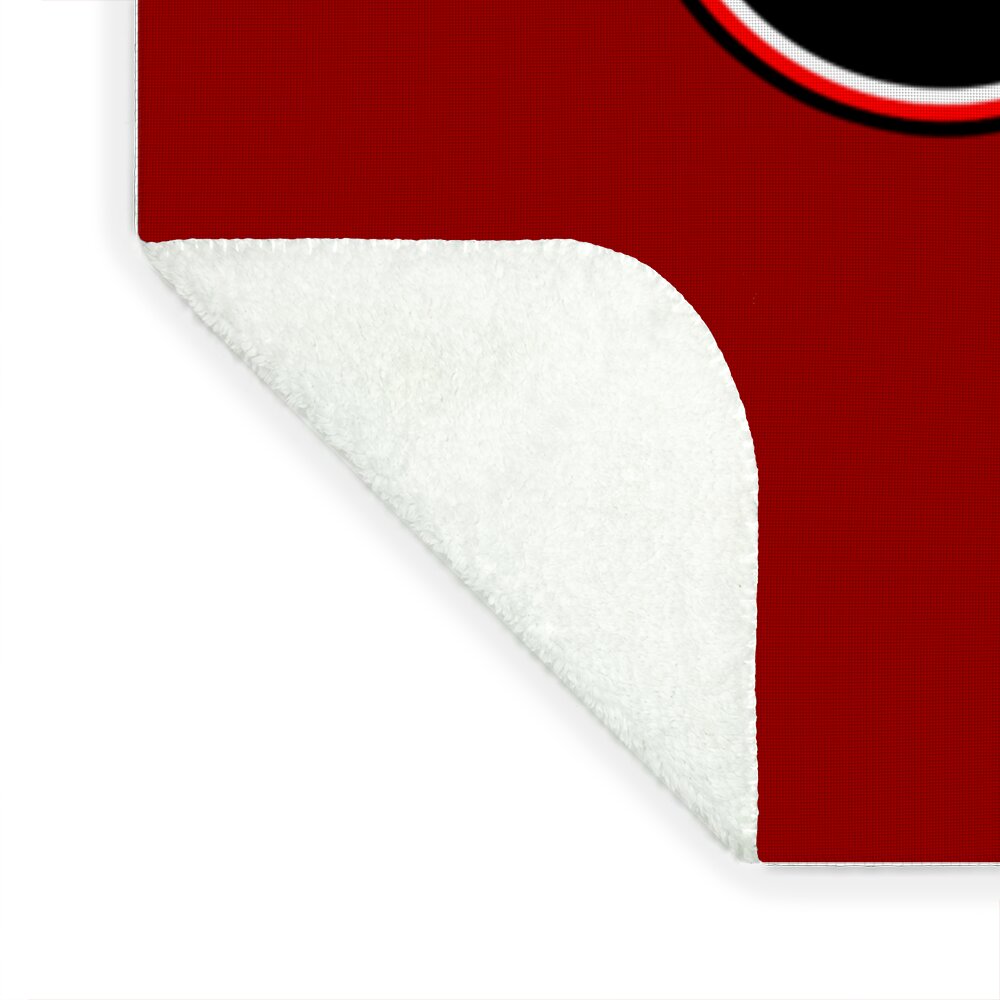 Fleece blanket corner with white underside and visible stitched edge