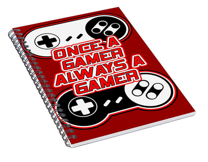 Red spiral notebook angled view with game controller icons and gamer slogan